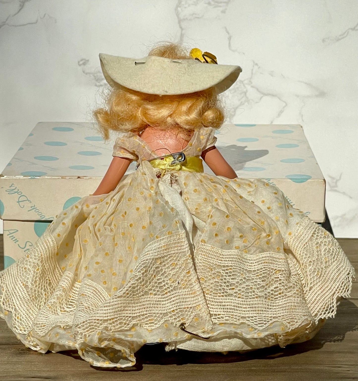 Nancy Ann storybook doll season series 91 summer doll antique collector doll yellow dress blonde hair yellow flower on hat original box frozen legs free shipping antique gift collector gift thebrokenbirdcompany christmas birthday gift for her mothers day 1940s collector doll cream colored box with blue polka dots