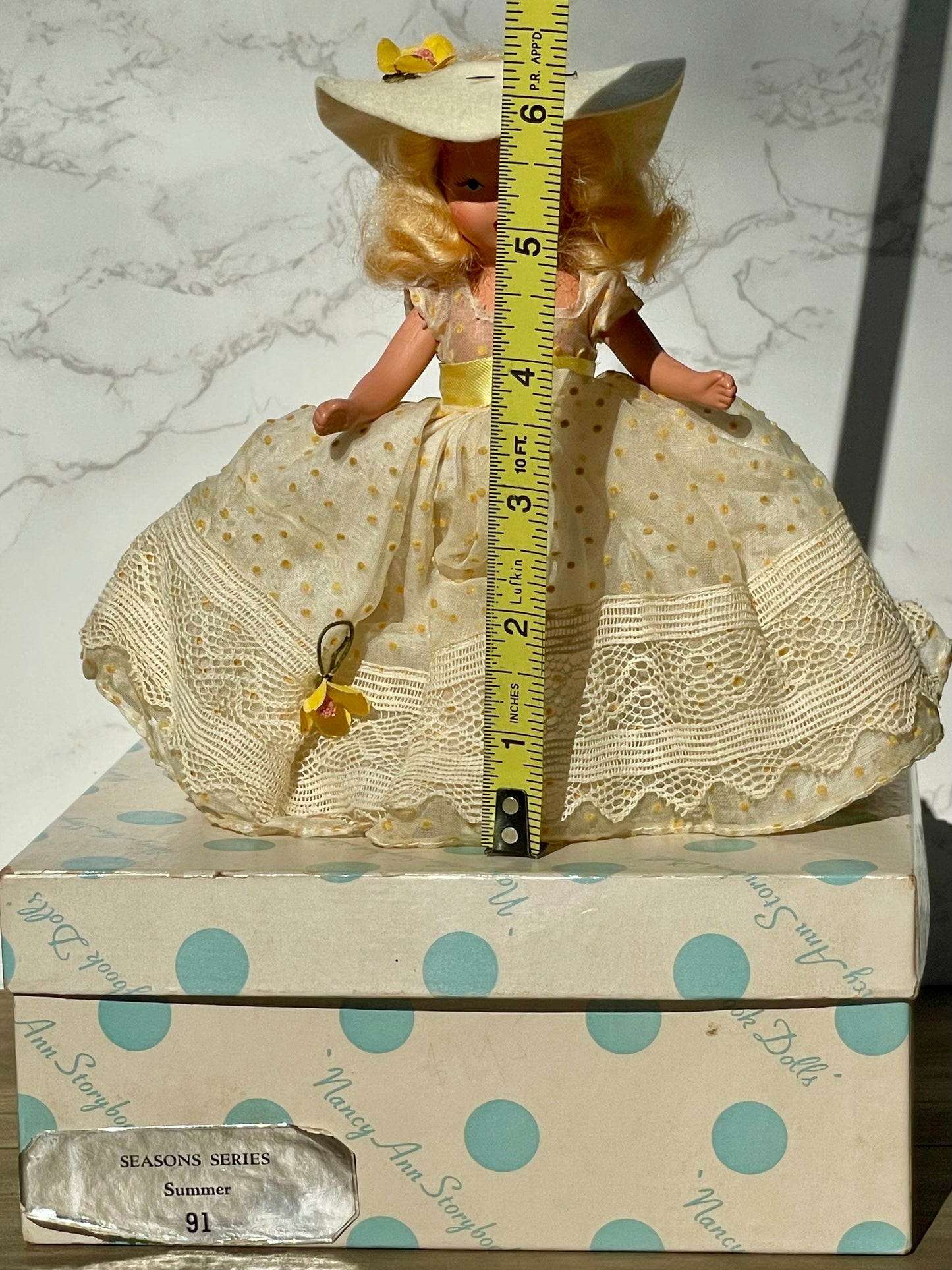 Nancy Ann storybook doll season series 91 summer doll antique collector doll yellow dress blonde hair yellow flower on hat original box frozen legs free shipping antique gift collector gift thebrokenbirdcompany christmas birthday gift for her mothers day 1940s collector doll cream colored box with blue polka dots