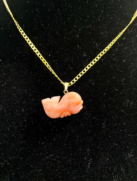 A salmon pink coral whale-shaped pendant with a gold clasp on a 16 inch gold-dipped necklace. Rare Vintage Salmon Pink Coral Whale Pendant NecklaceThebrokenbirdcompany rare coral necklace unique gift