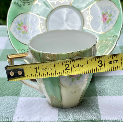 This beautiful tea cup and saucer set is made by United China and Glass Company during 1947 in occupied Japan, after WW2. Under the command of General Douglas MacArthur, all factories were required to print “occupied Japan” or “made in occupied Japan” between 1945 and 1952. This set is hand painted in green with white hearts outlined in gold. Tiny pink rosebuds are located at the center of the heart along with little blue leaves 