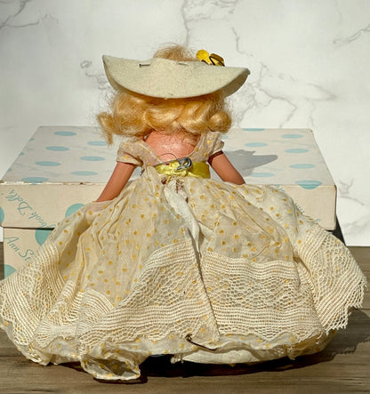 Nancy Ann storybook doll season series 91 summer doll antique collector doll yellow dress blonde hair yellow flower on hat original box frozen legs free shipping antique gift collector gift thebrokenbirdcompany christmas birthday gift for her mothers day 1940s collector doll cream colored box with blue polka dots