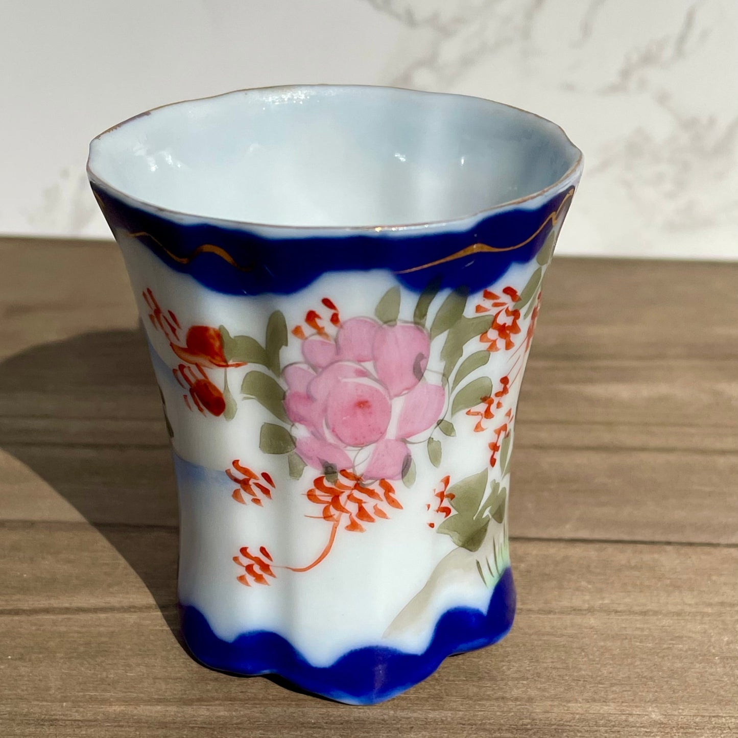 vintage sake tea cup with geisha and flowers hand painted japanese blue rimmed scalloped edge cup made in japan tall and selnder cup geisha girl in red dress red flowers gold embellishments green plants japanese landscape hand painted imagewhite porcelain scalloped base tea cup sake cup vintage gift asain inspired asain kitchen asain cup asain home decor thebrokenbirdcompany free shipping 