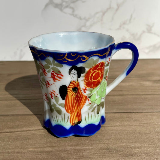 vintage sake tea cup with geisha and flowers hand painted japanese blue rimmed scalloped edge cup made in japan tall and selnder cup geisha girl in red dress red flowers gold embellishments green plants japanese landscape hand painted imagewhite porcelain scalloped base tea cup sake cup vintage gift asain inspired asain kitchen asain cup asain home decor thebrokenbirdcompany free shipping 