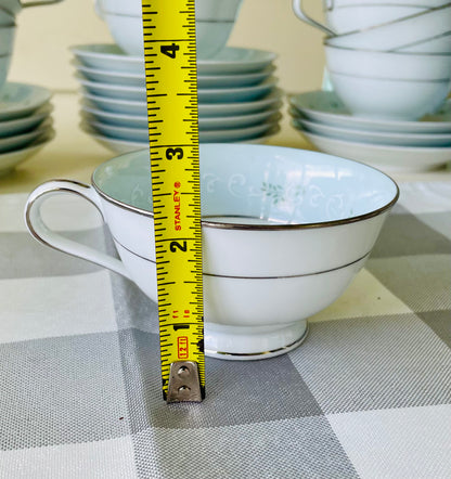 Noritake's discontinued Martha #6344 pattern, produced from 1962-1968, a military-exclusive treasure hand-painted for American families abroad, now ready to steal the show at your next porch supper or holiday feast. Includes 95 pieces (listed below) adored with baby blue trim, white filigree designs mixed with green leafy accents, topped off with a beautiful platinum rim