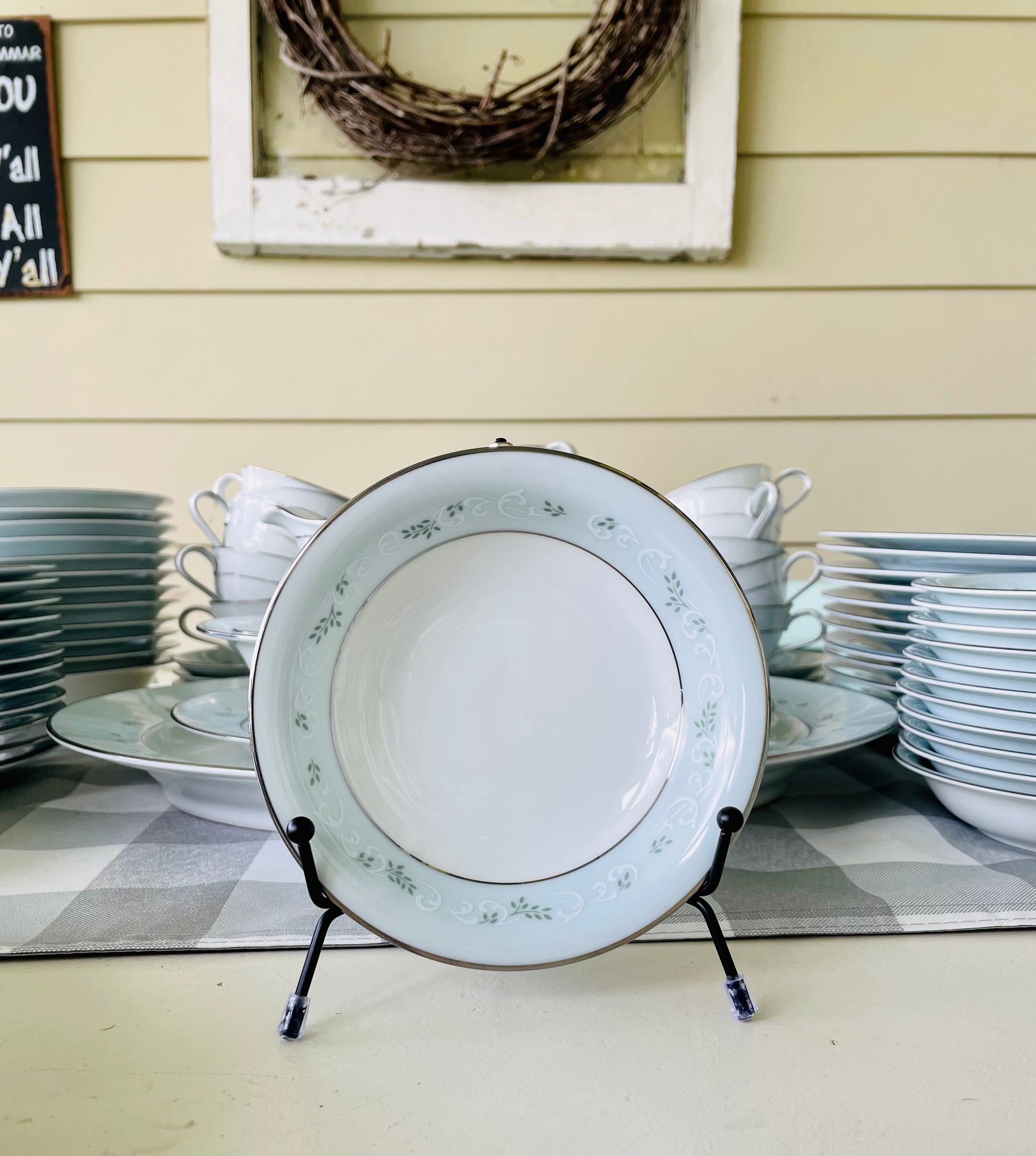 Noritake's discontinued Martha #6344 pattern, produced from 1962-1968, a military-exclusive treasure hand-painted for American families abroad, now ready to steal the show at your next porch supper or holiday feast. Includes 95 pieces (listed below) adored with baby blue trim, white filigree designs mixed with green leafy accents, topped off with a beautiful platinum rim