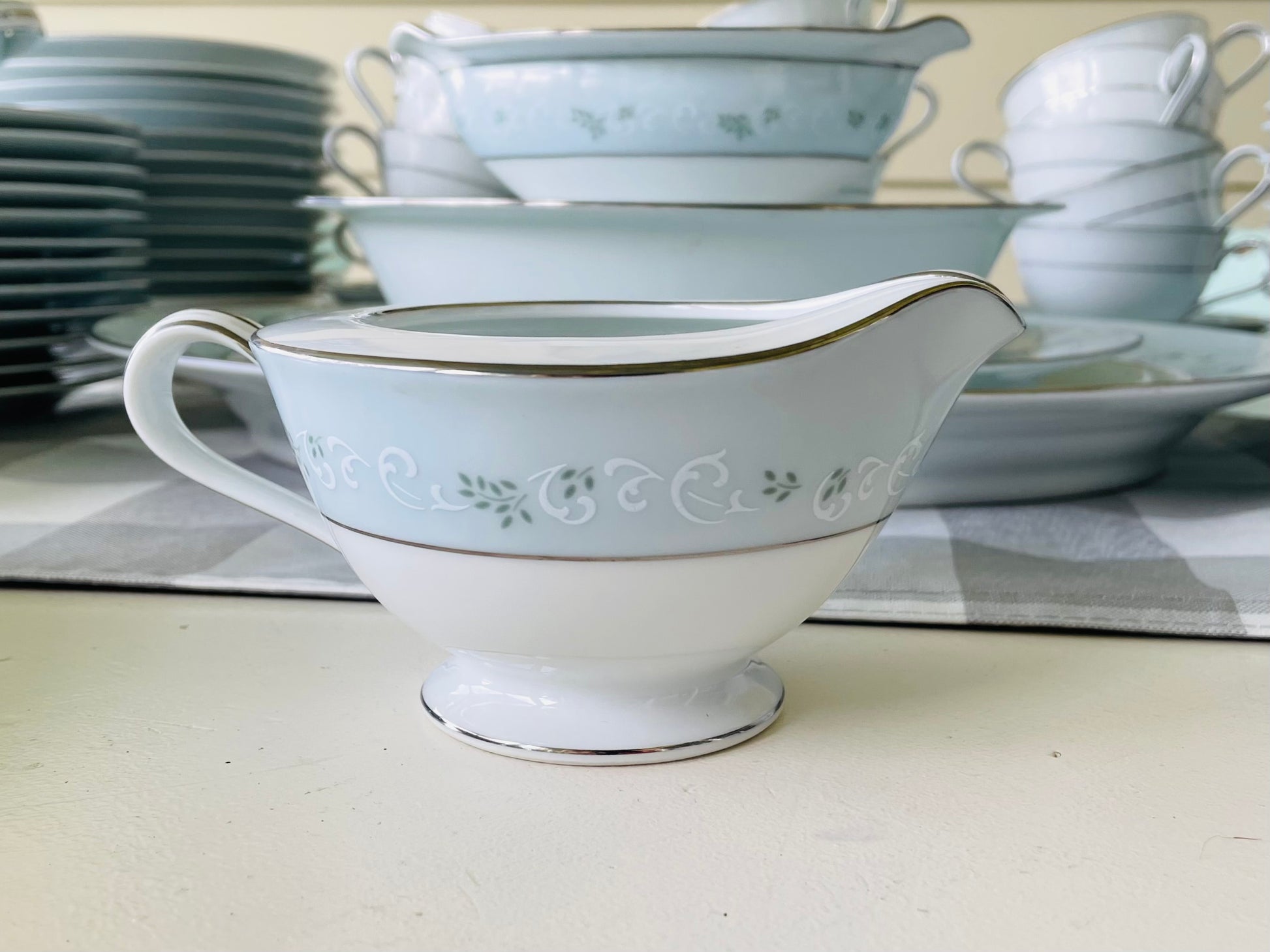 Noritake's discontinued Martha #6344 pattern, produced from 1962-1968, a military-exclusive treasure hand-painted for American families abroad, now ready to steal the show at your next porch supper or holiday feast. Includes 95 pieces (listed below) adored with baby blue trim, white filigree designs mixed with green leafy accents, topped off with a beautiful platinum rim