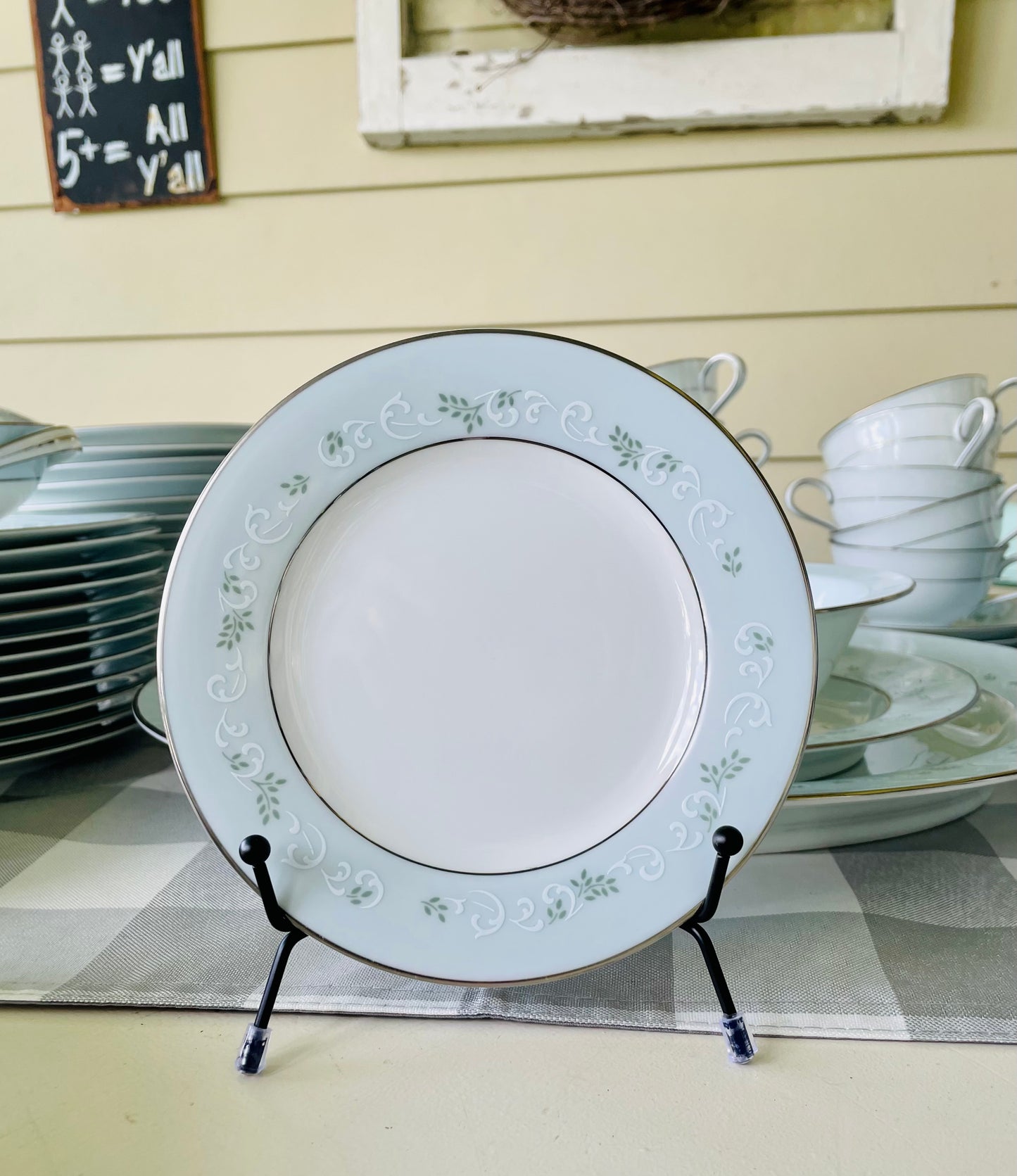 Noritake's discontinued Martha #6344 pattern, produced from 1962-1968, a military-exclusive treasure hand-painted for American families abroad, now ready to steal the show at your next porch supper or holiday feast. Includes 95 pieces (listed below) adored with baby blue trim, white filigree designs mixed with green leafy accents, topped off with a beautiful platinum rim