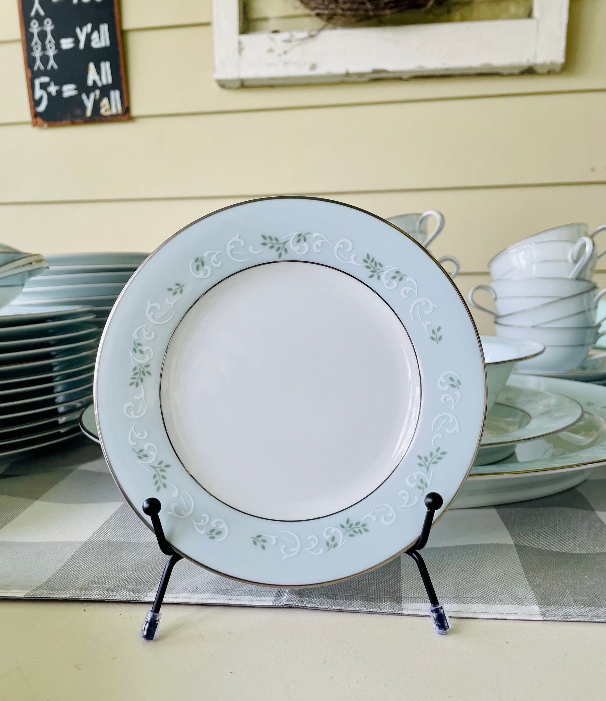 Noritake's discontinued Martha #6344 pattern, produced from 1962-1968, a military-exclusive treasure hand-painted for American families abroad, now ready to steal the show at your next porch supper or holiday feast. Includes 95 pieces (listed below) adored with baby blue trim, white filigree designs mixed with green leafy accents, topped off with a beautiful platinum rim