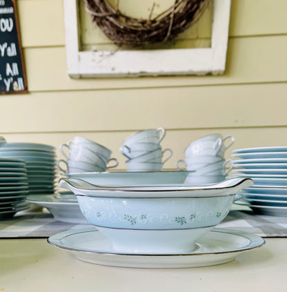Noritake's discontinued Martha #6344 pattern, produced from 1962-1968, a military-exclusive treasure hand-painted for American families abroad, now ready to steal the show at your next porch supper or holiday feast. Includes 95 pieces (listed below) adored with baby blue trim, white filigree designs mixed with green leafy accents, topped off with a beautiful platinum rim