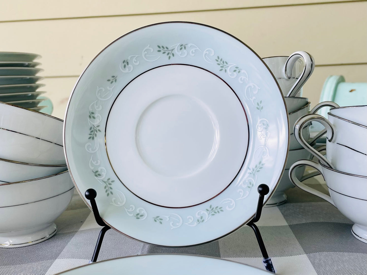 Noritake's discontinued Martha #6344 pattern, produced from 1962-1968, a military-exclusive treasure hand-painted for American families abroad, now ready to steal the show at your next porch supper or holiday feast. Includes 95 pieces (listed below) adored with baby blue trim, white filigree designs mixed with green leafy accents, topped off with a beautiful platinum rim