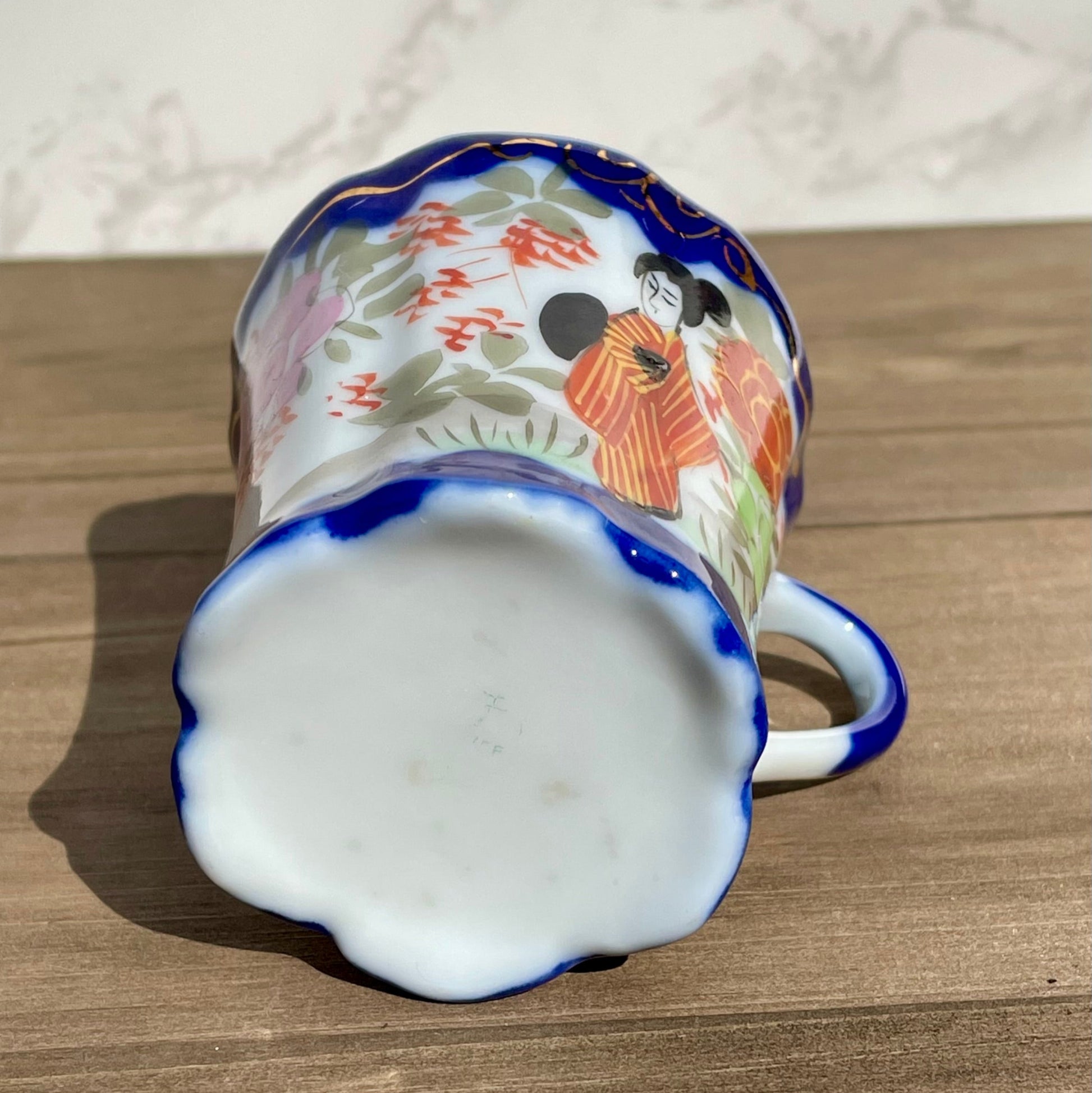 vintage sake tea cup with geisha and flowers hand painted japanese blue rimmed scalloped edge cup made in japan tall and selnder cup geisha girl in red dress red flowers gold embellishments green plants japanese landscape hand painted imagewhite porcelain scalloped base tea cup sake cup vintage gift asain inspired asain kitchen asain cup asain home decor thebrokenbirdcompany free shipping 